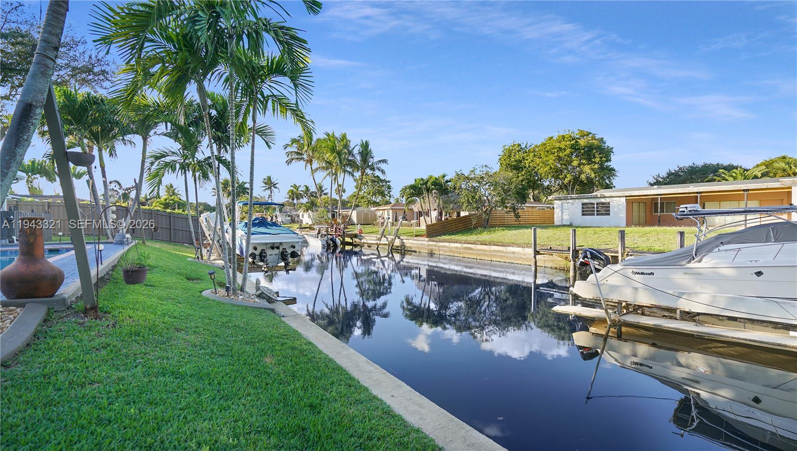 5921 Southwest 17th Street Plantation, FL 33317 - Photo 43 of 53 a view of a swimming pool with a patio and a yard