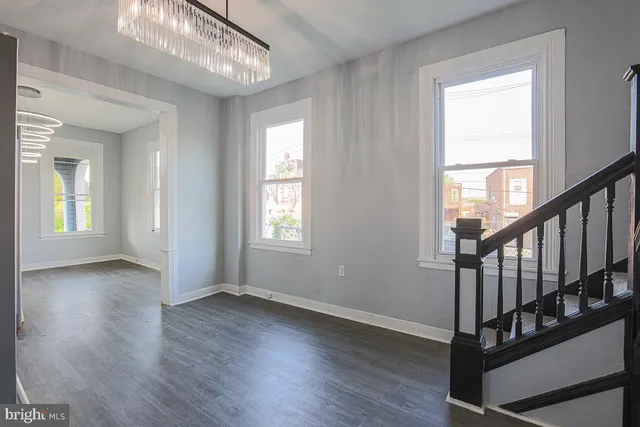 a view of entryway and hall with wooden floor