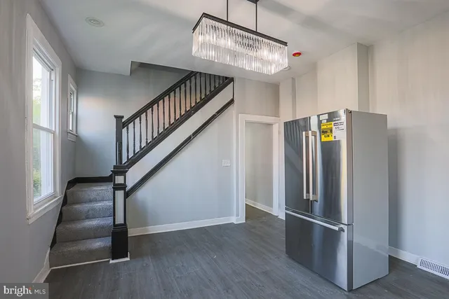 a kitchen with granite countertop white cabinets and stainless steel appliances