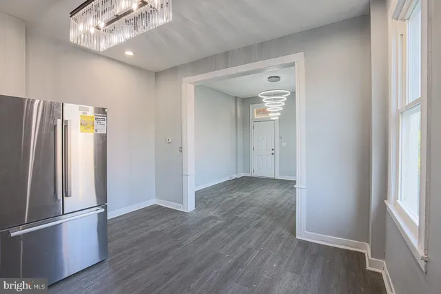 a kitchen with white cabinets and appliances