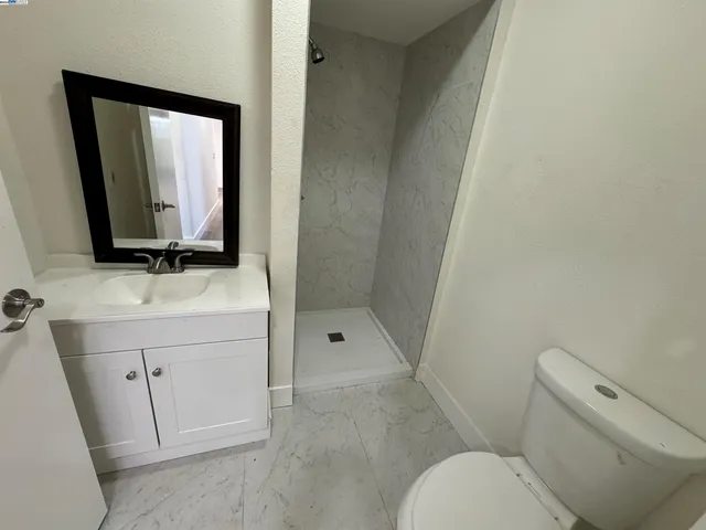 a white toilet sitting next to a bathroom sink