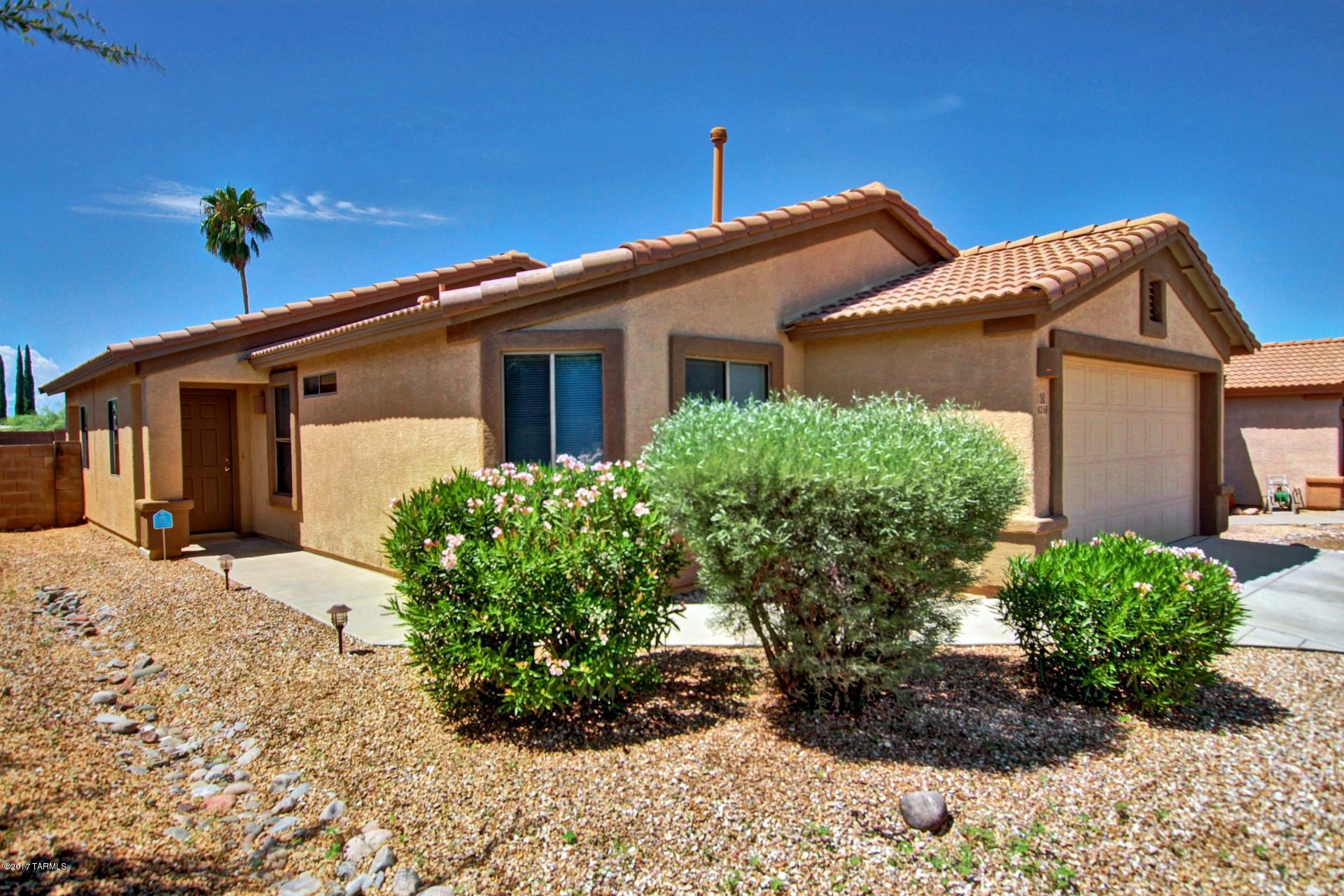 8350 East Bowline Road Tucson, AZ 85710 - Photo 1 of 26 a front view of a house with a yard