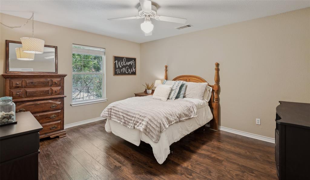 1000 Ballard Road Van Alstyne, TX 75495 - Photo 29 of 40 a bedroom with a bed and a flat tv screen on dresser