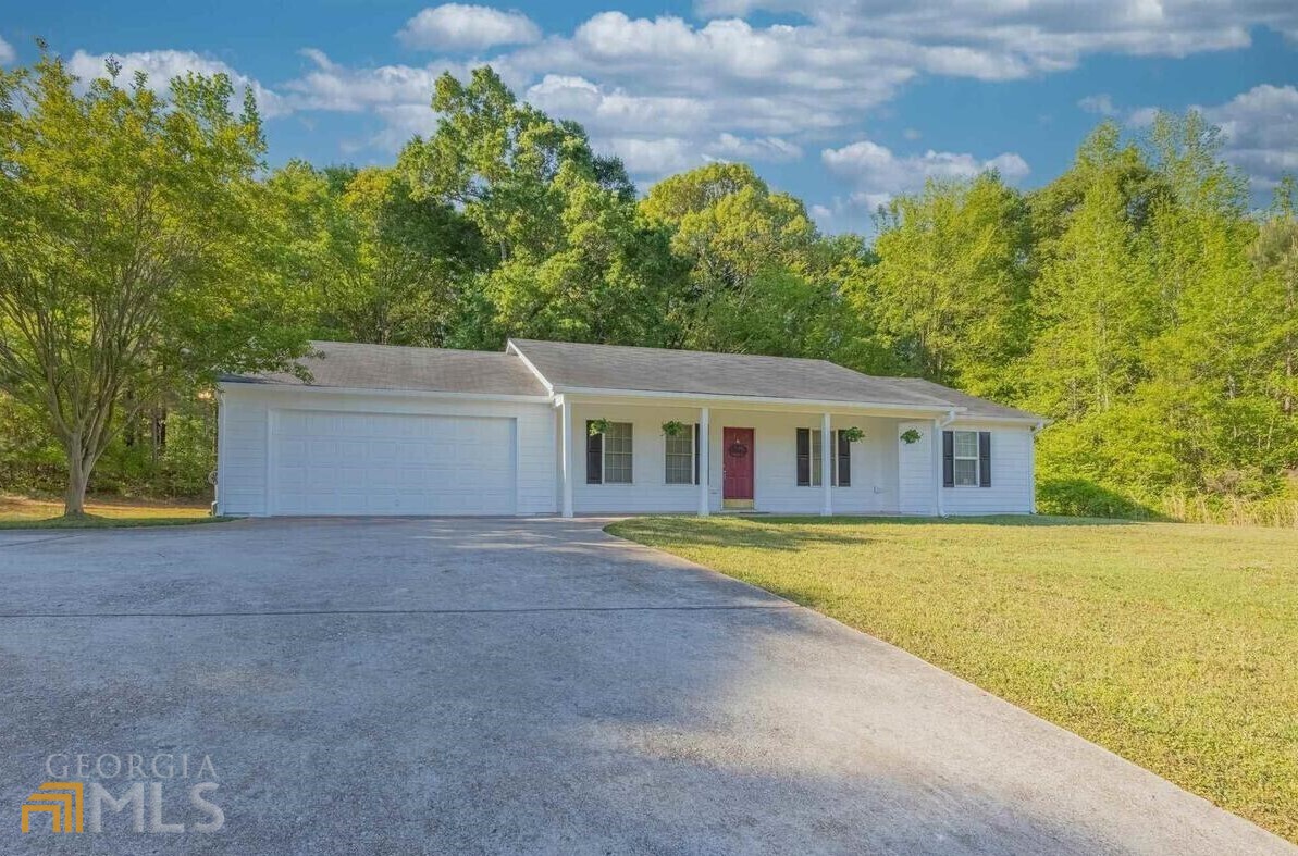7151 Stone Bridge Road Carnesville, GA 30521 - Photo 1 of 1 a front view of a house with a yard and trees