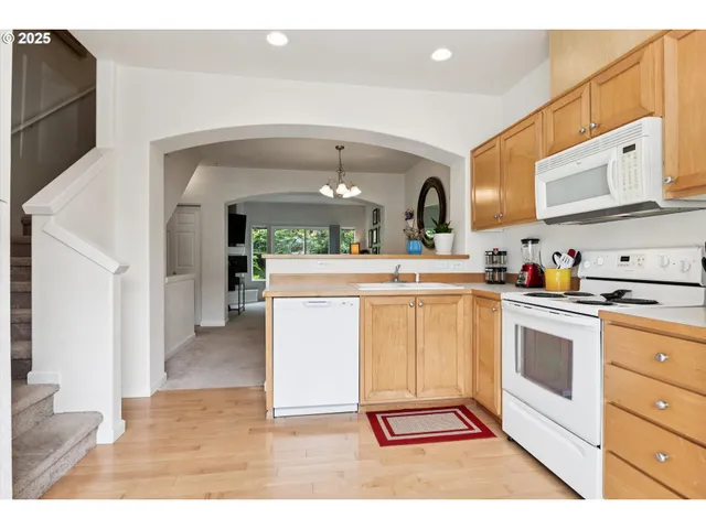 a kitchen with stainless steel appliances a refrigerator sink and cabinets