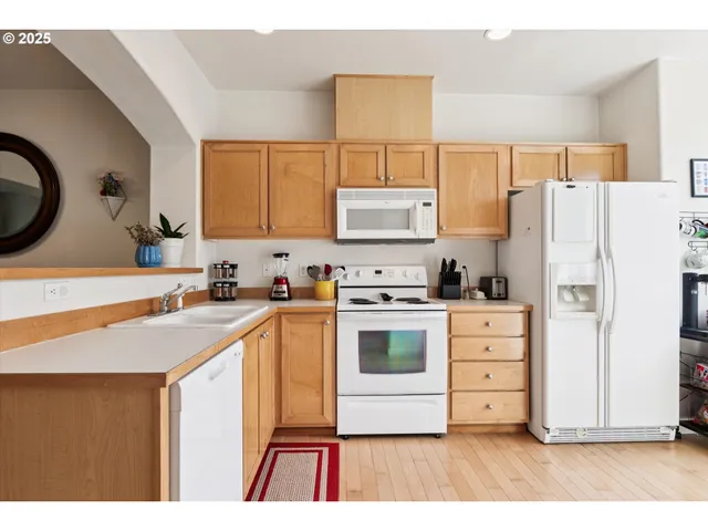 a kitchen with stainless steel appliances a stove a refrigerator and a cabinets