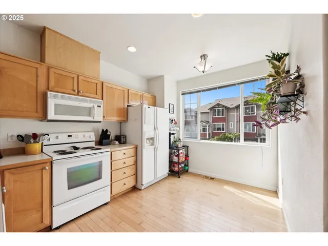 a kitchen with a stove a sink and a refrigerator