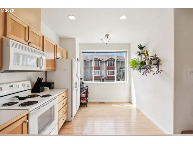 a view of a room with a window and hardwood floor