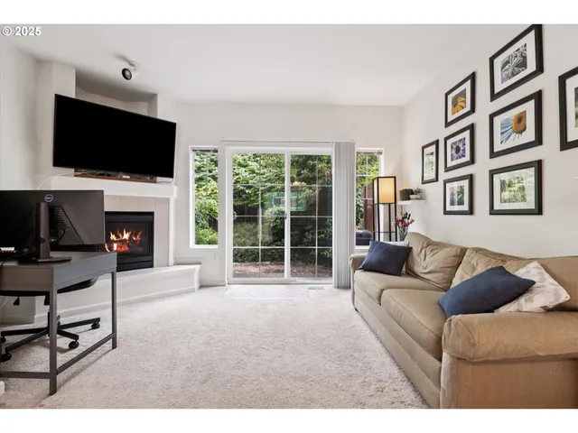 a living room with furniture a fireplace and a flat screen tv
