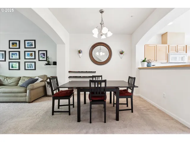 a view of a dining room with furniture and chandelier