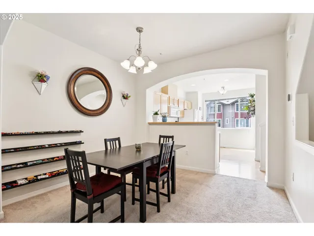 a view of a dining room with furniture and chandelier