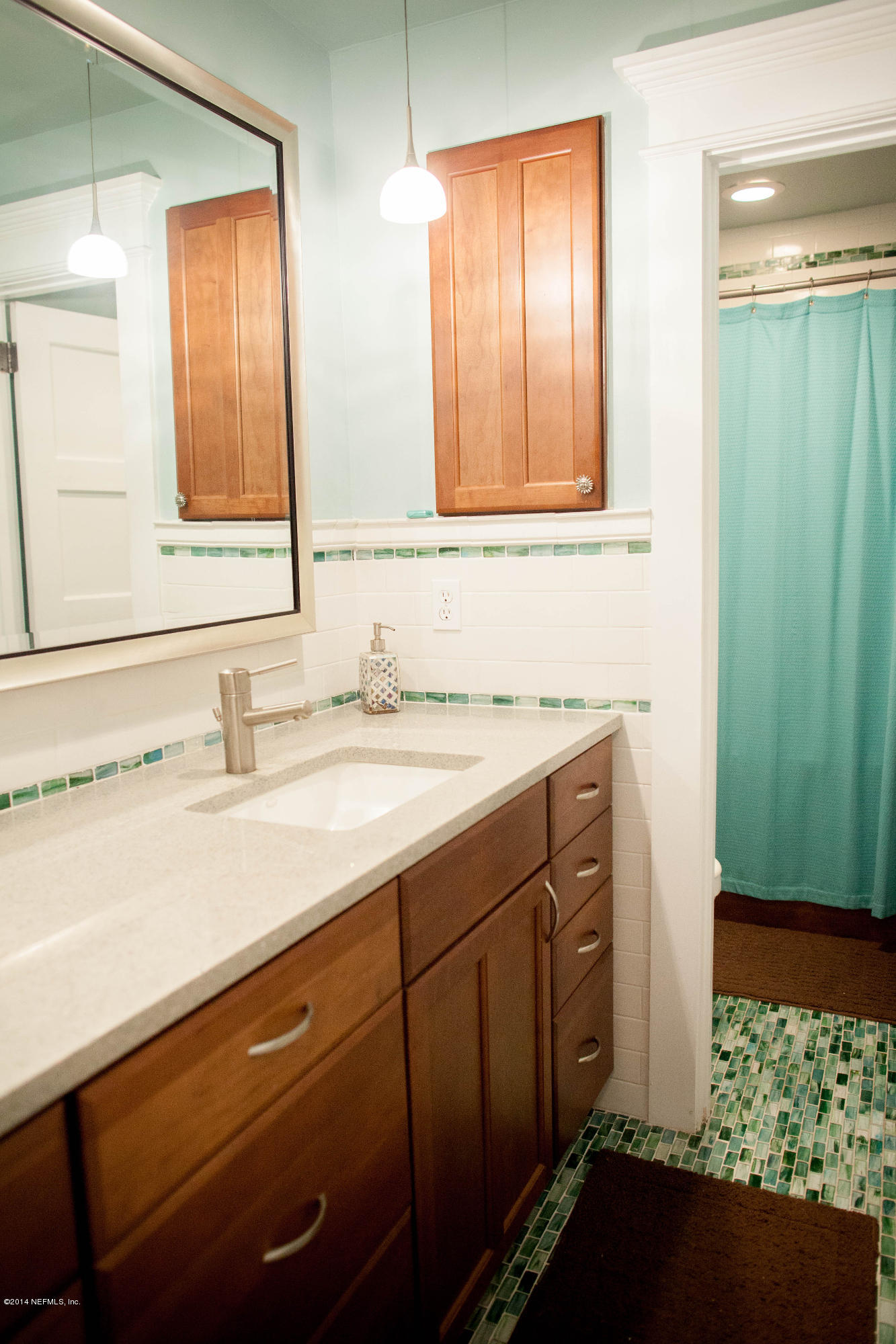 310 7th Street Atlantic Beach, FL 32233 - Photo 11 of 37 a bathroom with a sink and a mirror