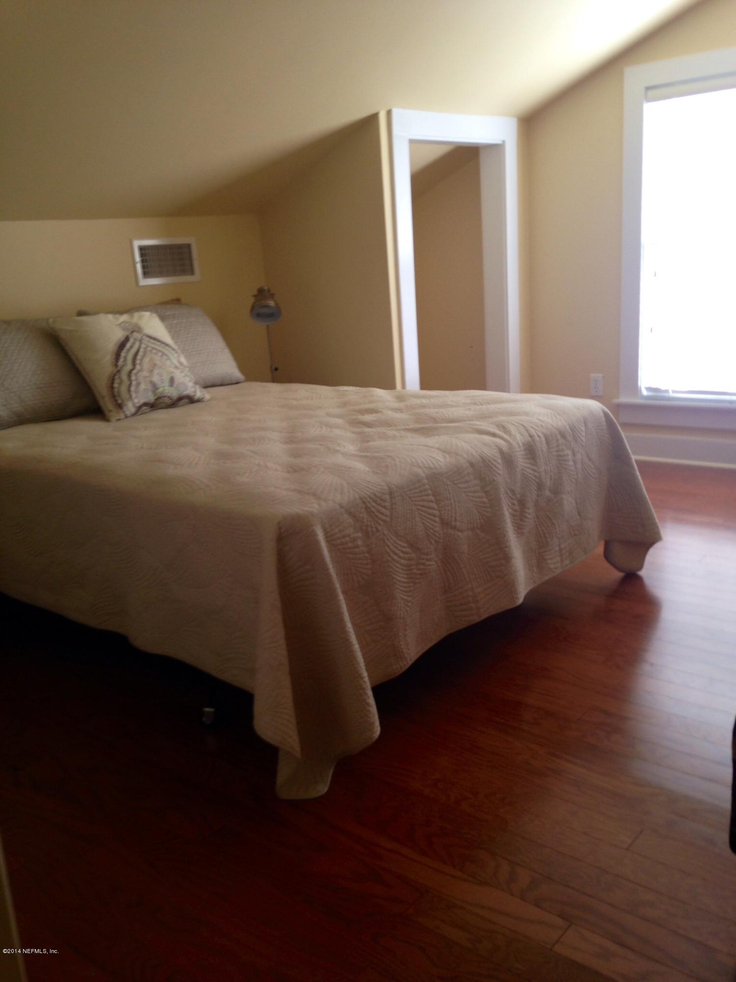 310 7th Street Atlantic Beach, FL 32233 - Photo 15 of 37 a bedroom with a bed and wooden floor