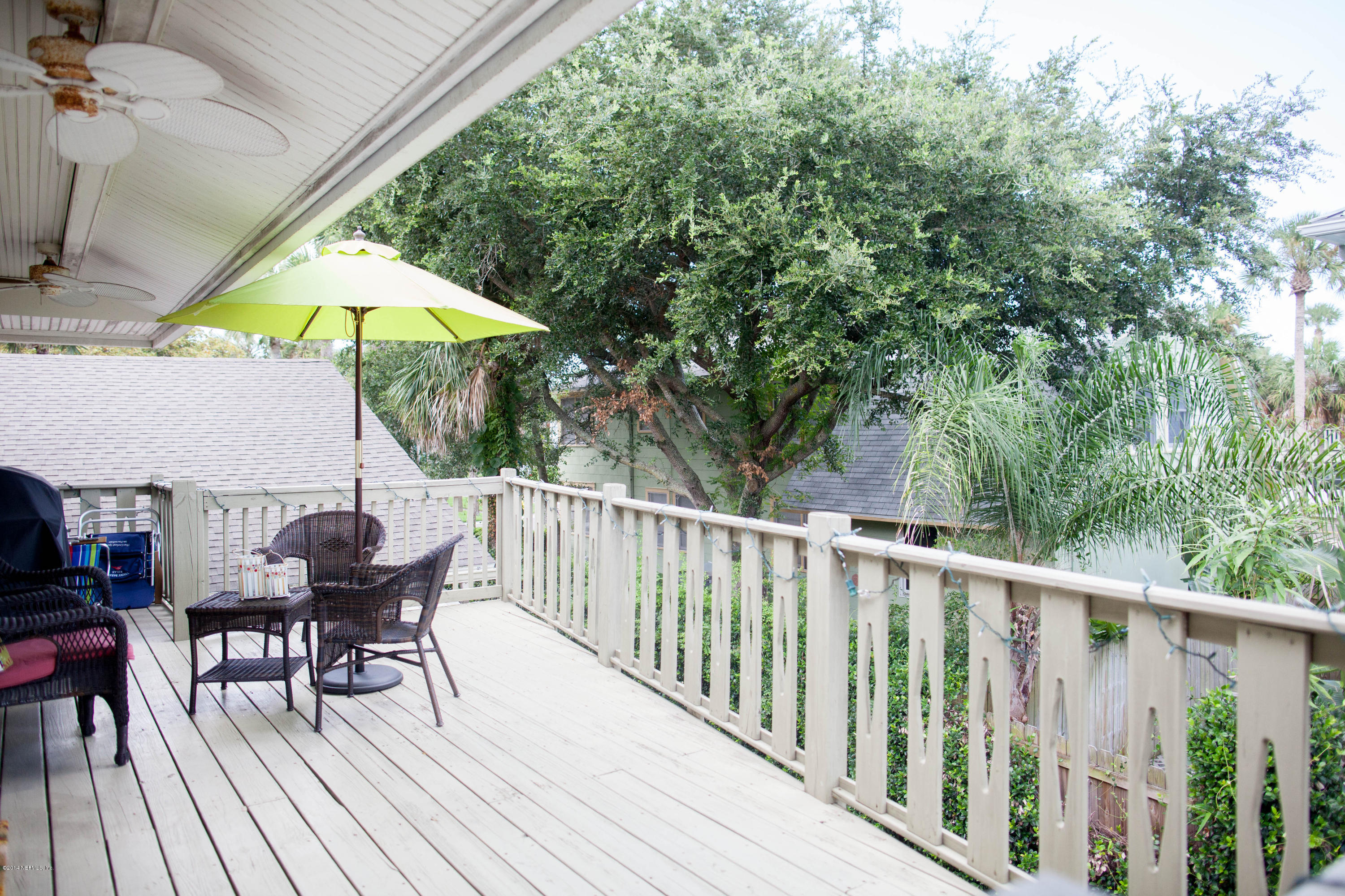 310 7th Street Atlantic Beach, FL 32233 - Photo 22 of 37 a view of balcony with furniture and umbrella