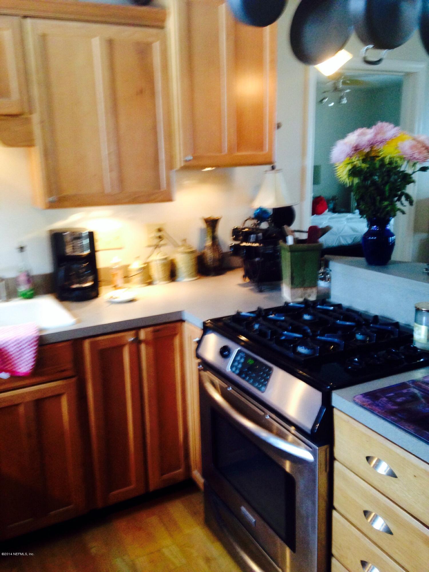 310 7th Street Atlantic Beach, FL 32233 - Photo 25 of 37 a kitchen with stainless steel appliances granite countertop a stove a sink dishwasher and cabinets with wooden floor