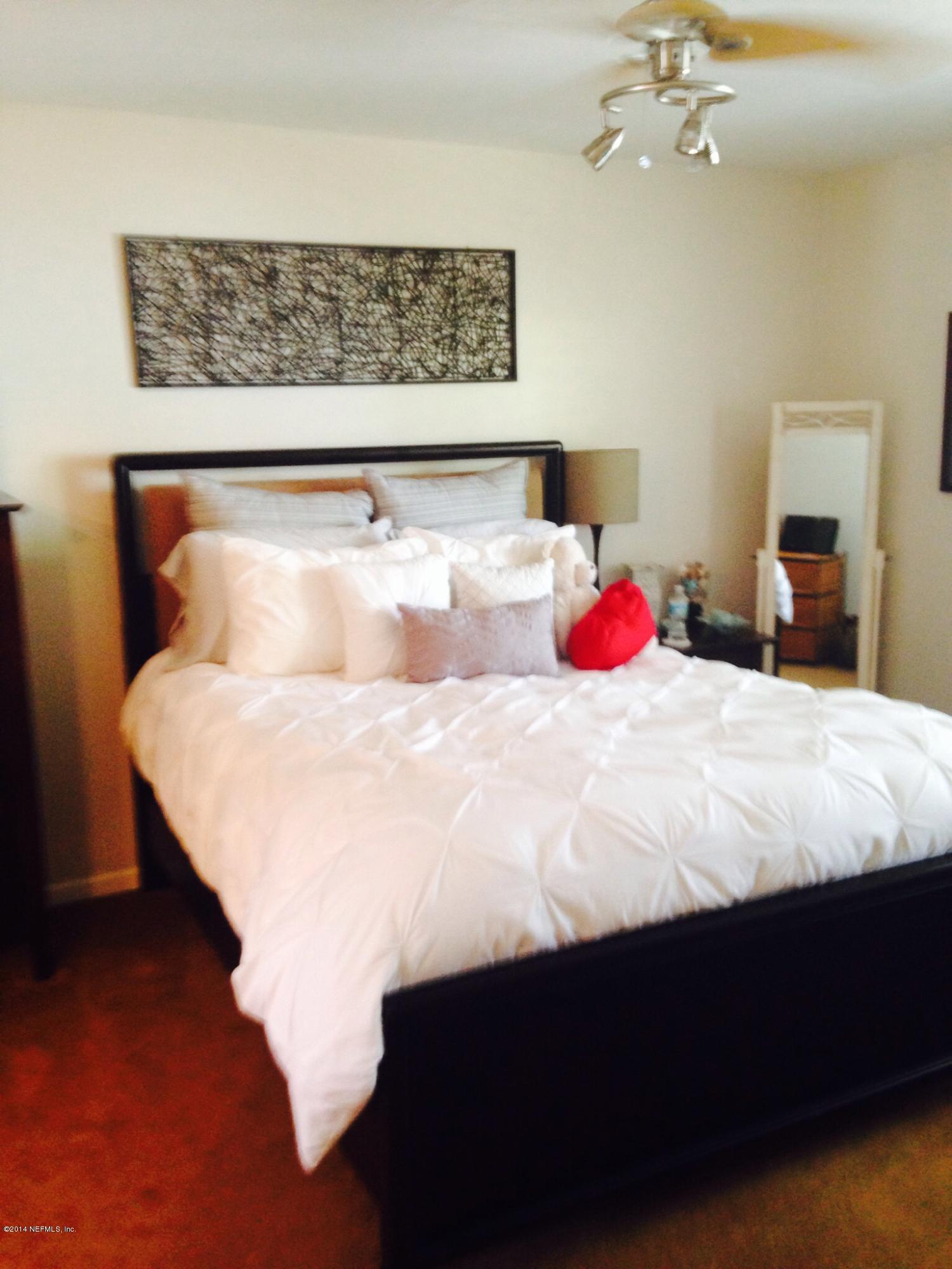 310 7th Street Atlantic Beach, FL 32233 - Photo 26 of 37 a bedroom with a bed and window
