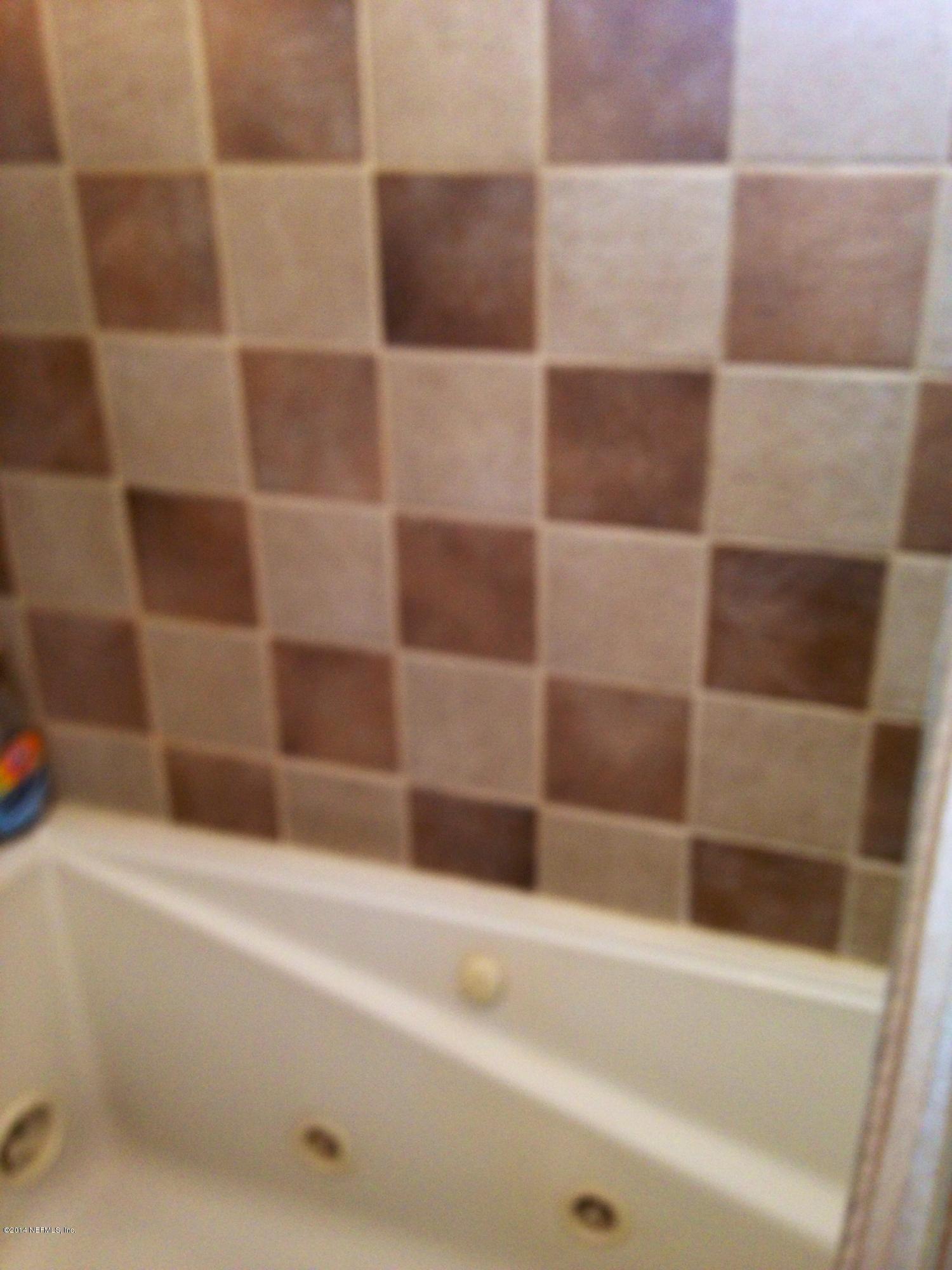310 7th Street Atlantic Beach, FL 32233 - Photo 27 of 37 a bathroom with a bathtub