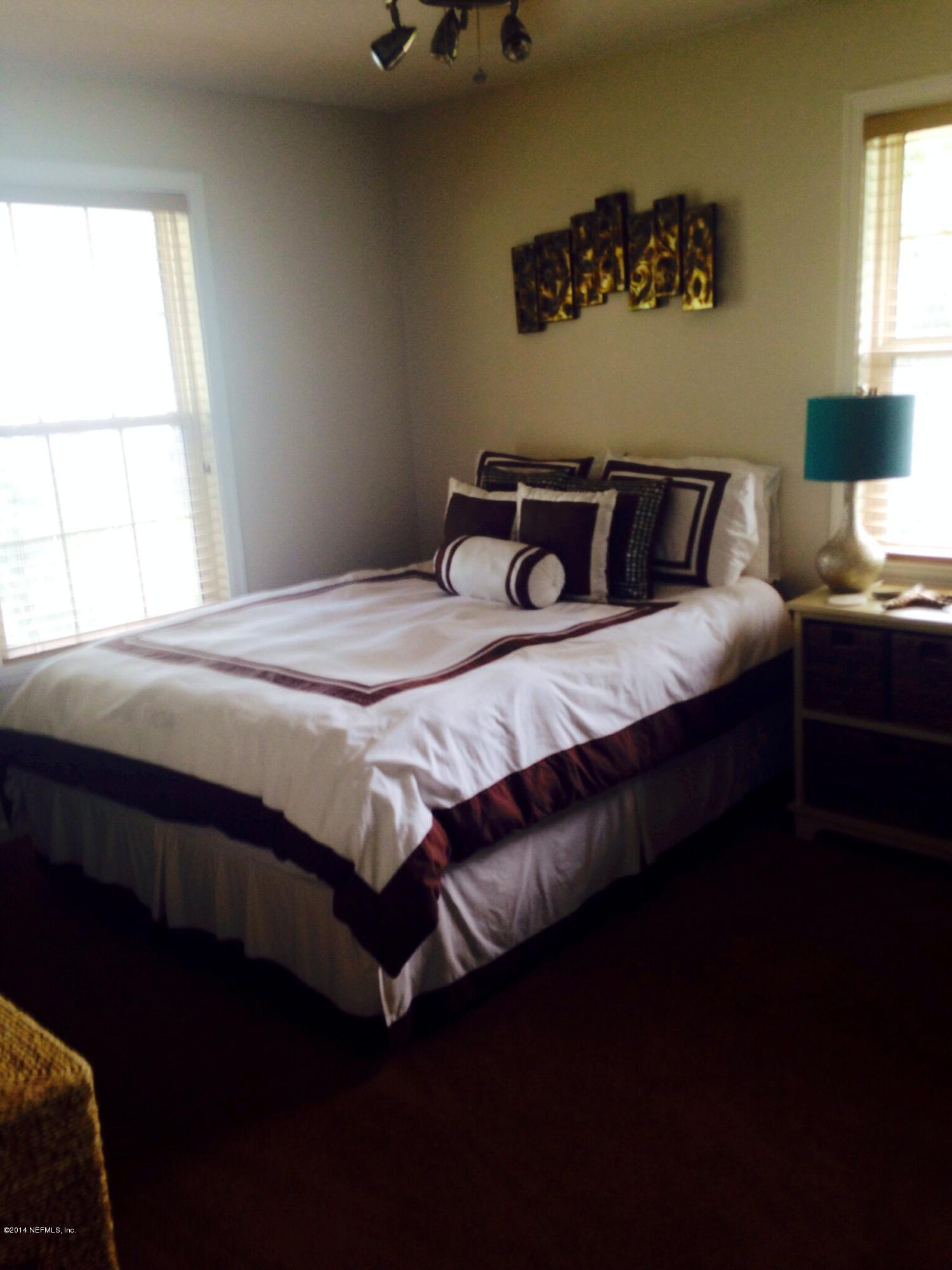 310 7th Street Atlantic Beach, FL 32233 - Photo 28 of 37 a bedroom with a bed and window