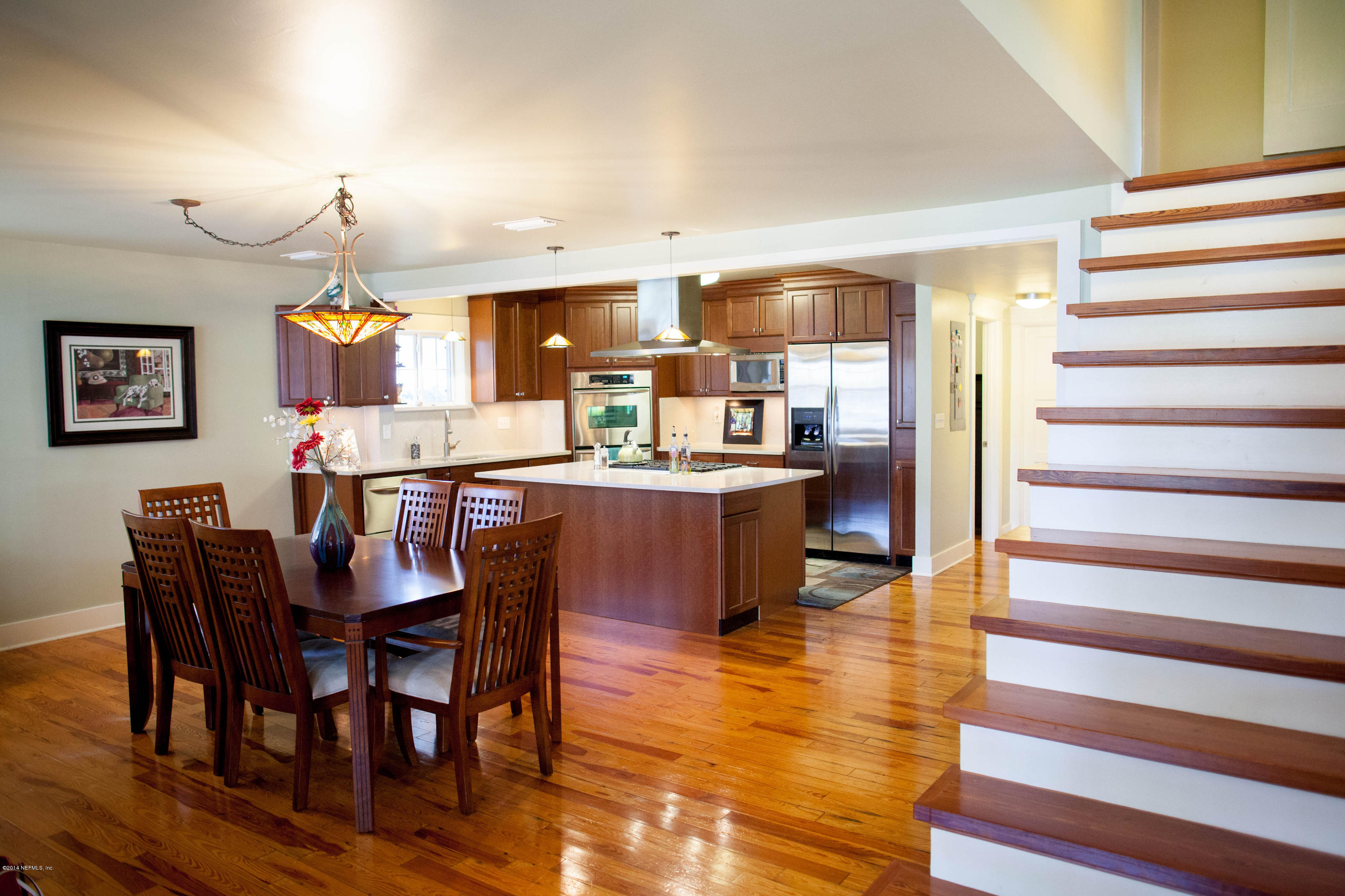 310 7th Street Atlantic Beach, FL 32233 - Photo 5 of 37 a dining hall with stainless steel appliances a dining table and chairs with wooden floor