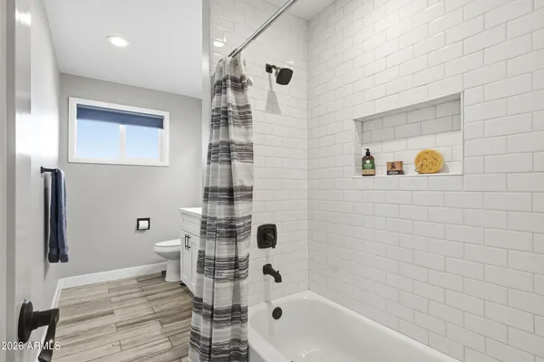 a bathroom with a bathtub and shower