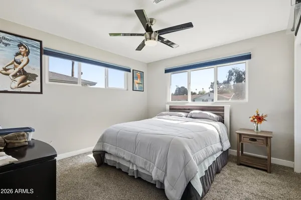 a bedroom with a bed and a window