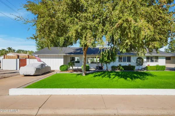 a view of a patio with a table and chairs and potted plants