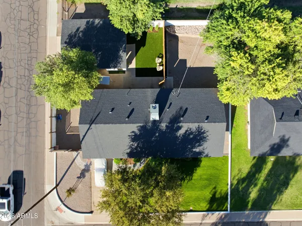an aerial view of a house with a yard basket ball court and a fountain
