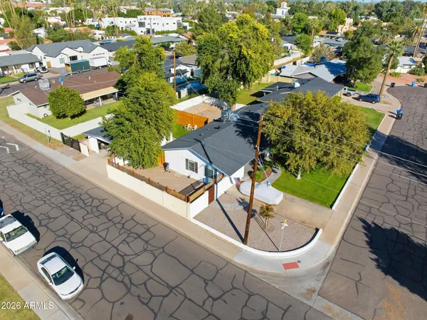 an aerial view of a chairs and table on the balcony