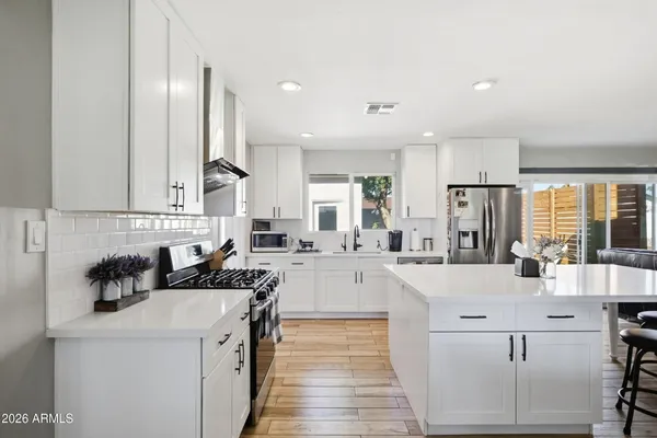 a kitchen with counter top space cabinets and appliances