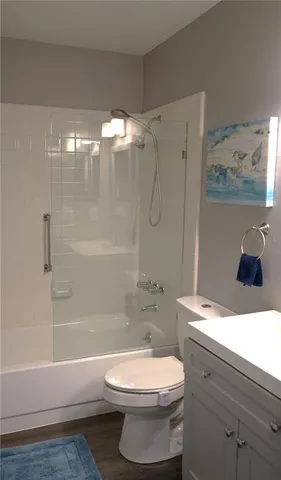 a bathroom with a toilet sink and shower