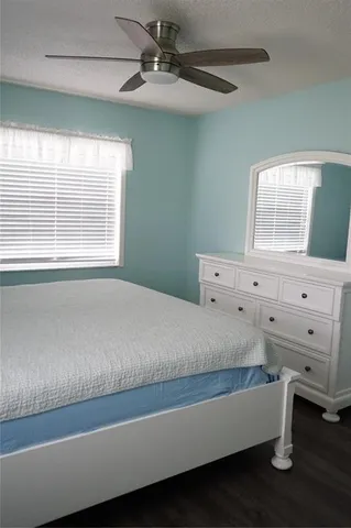 a bed sitting in a bedroom next to a window