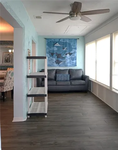 a living room with chairs and a window