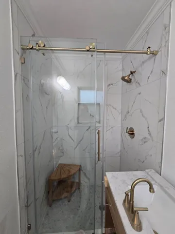 a bathroom with a granite countertop sink toilet and shower