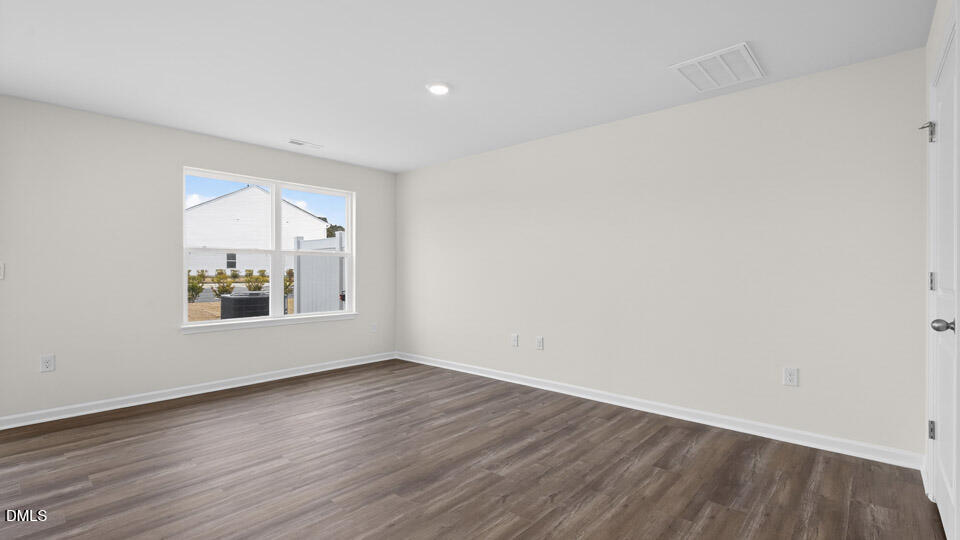 27 Red Clover Drive Angier, NC 27501 - Photo 12 of 28 a view of an empty room with wooden floor and a window