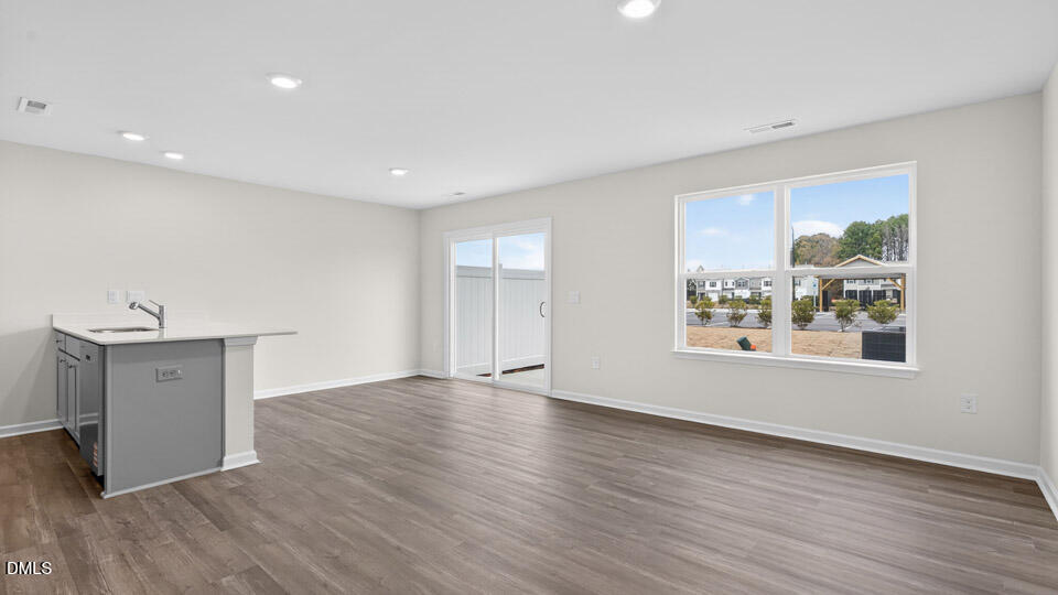 27 Red Clover Drive Angier, NC 27501 - Photo 9 of 28 a view of an empty room with wooden floor and a window