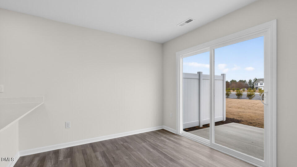 27 Red Clover Drive Angier, NC 27501 - Photo 10 of 28 a view of a room with wooden floor and glass door