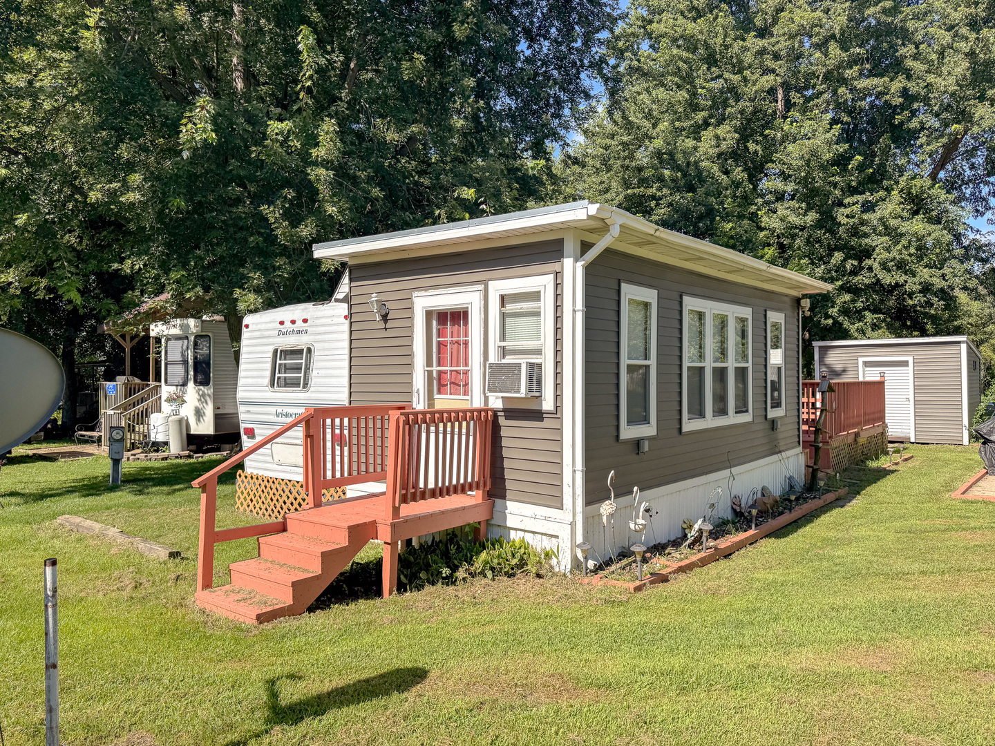 a view of a house with a yard and sitting area