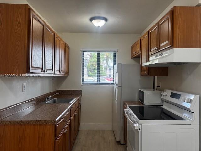 1310 West 29th Street, Unit 22 Hialeah, FL 33012 - Photo 15 of 16 a kitchen that has a sink and a stove