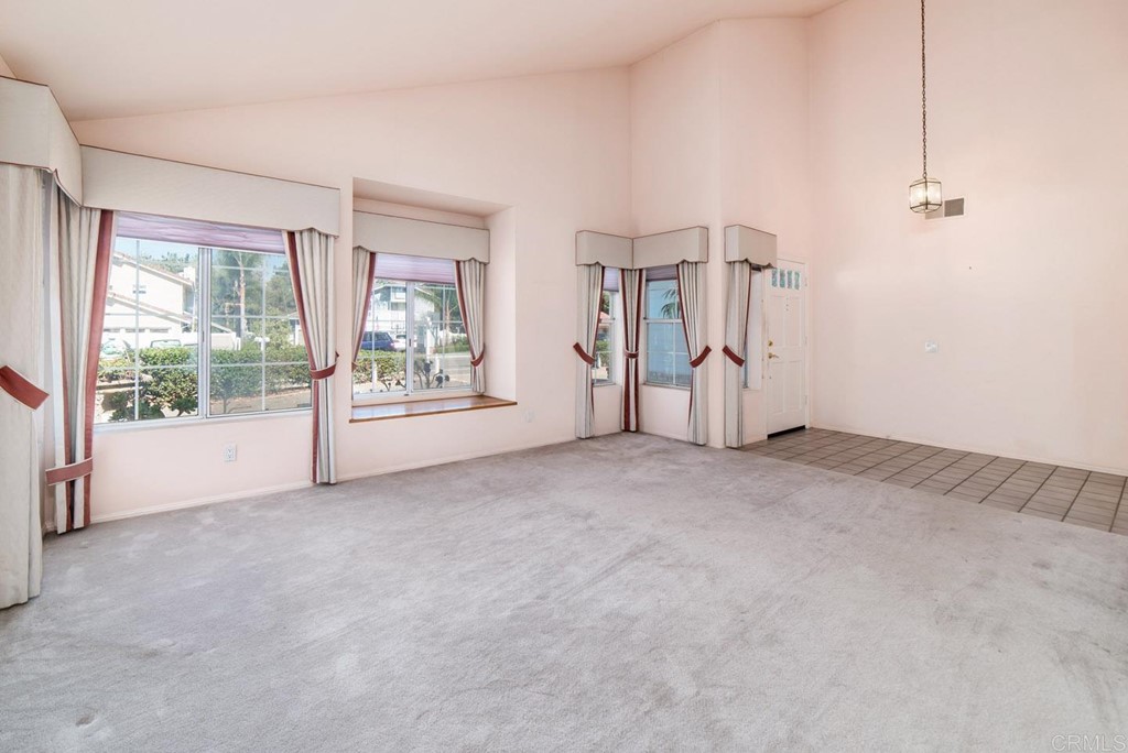887 Quail Hill Drive San Marcos, CA 92078 - Photo 2 of 22 a view of an empty room with a window