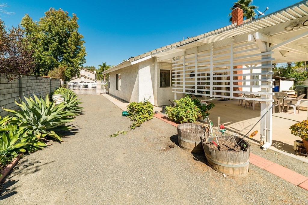 887 Quail Hill Drive San Marcos, CA 92078 - Photo 13 of 22 a blue swimming pool with yard and outdoor seating