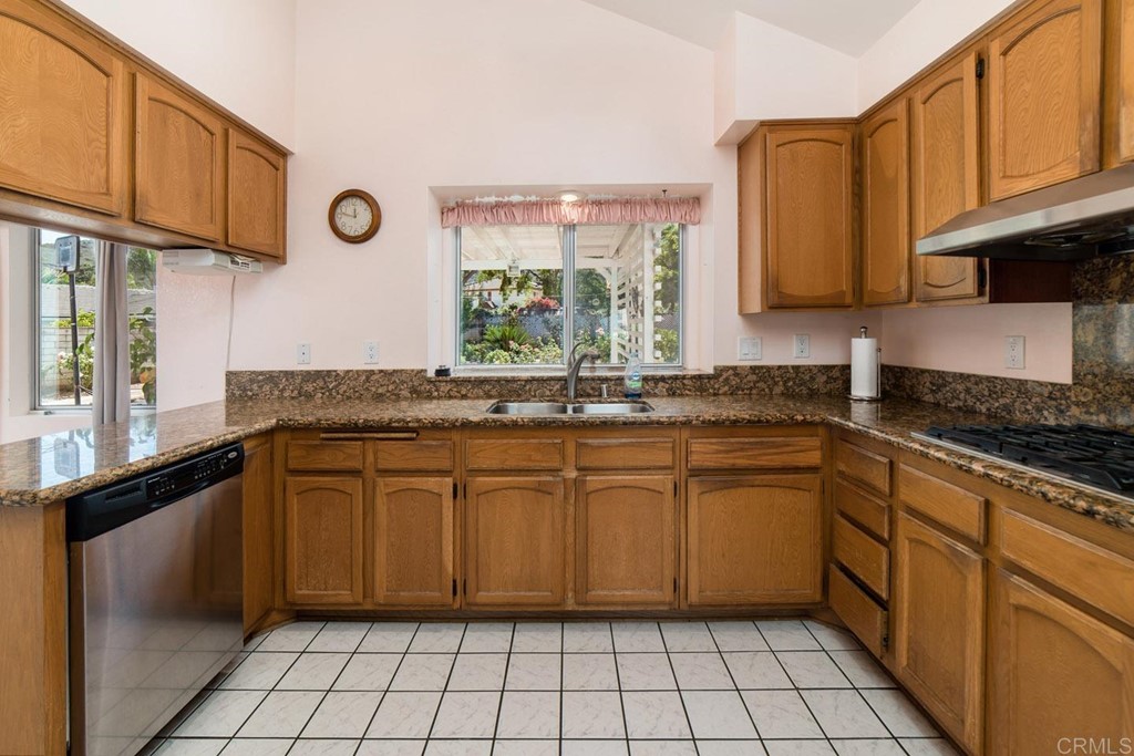887 Quail Hill Drive San Marcos, CA 92078 - Photo 5 of 22 a kitchen with granite countertop a sink and a stove
