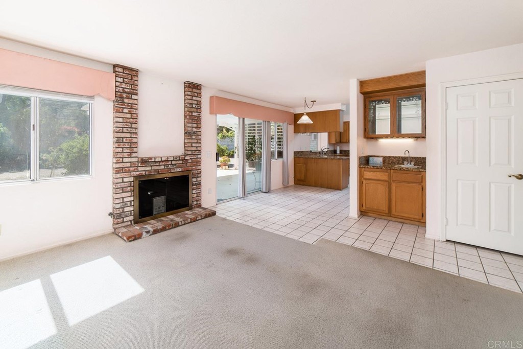 887 Quail Hill Drive San Marcos, CA 92078 - Photo 8 of 22 an empty room with furniture and a fireplace