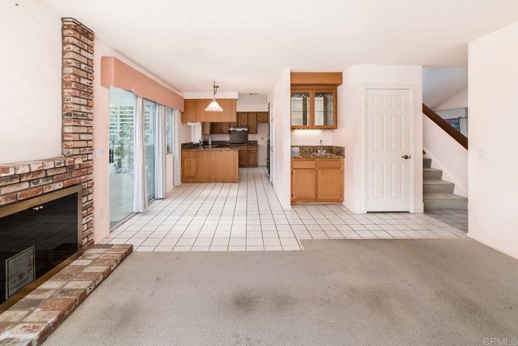 887 Quail Hill Drive San Marcos, CA 92078 - Photo 9 of 22 a view of a kitchen with a sink cabinets and a living room