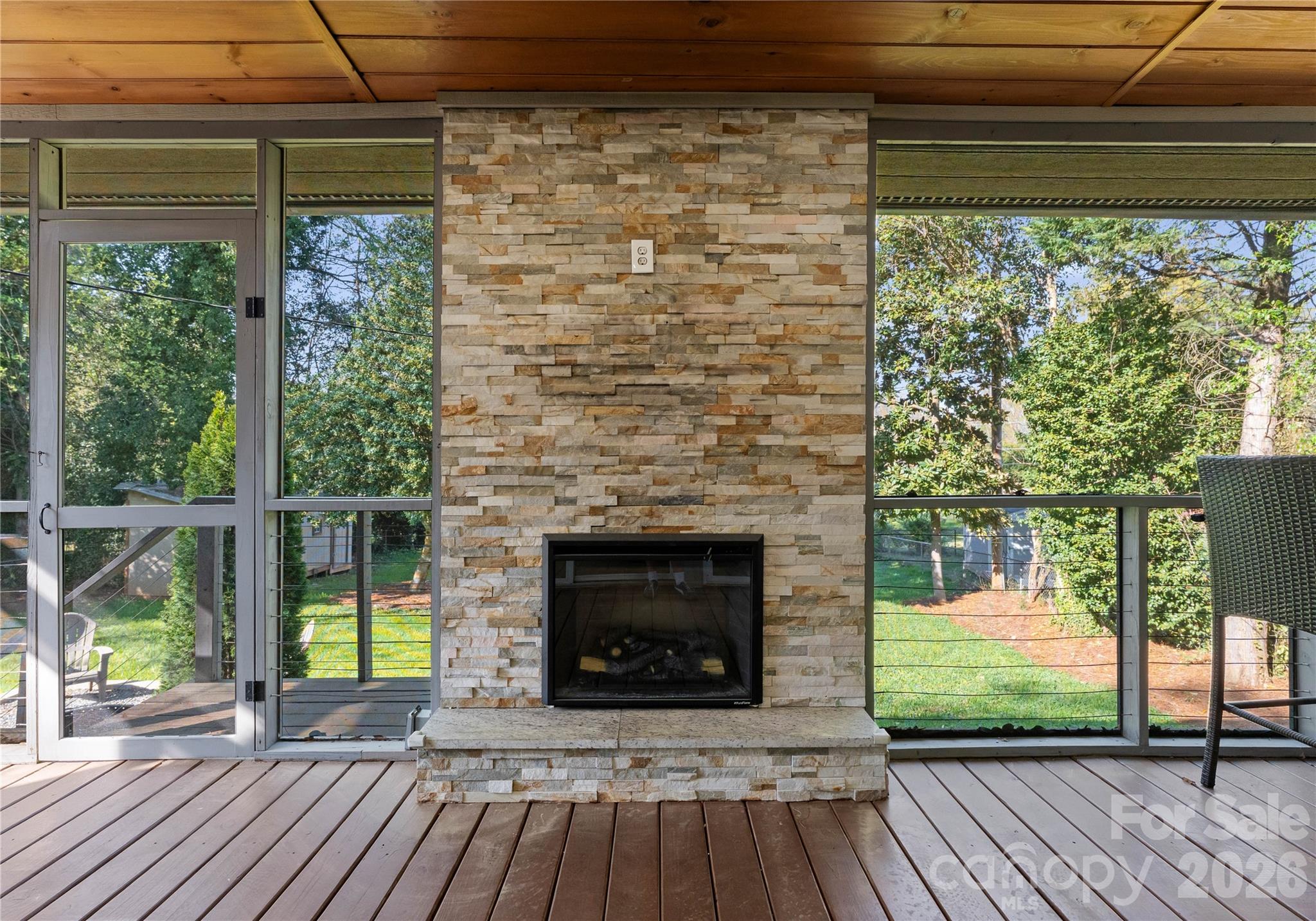 5100 White Oak Road Charlotte, NC 28210 - Photo 32 of 43 a living room with a fireplace and a floor to ceiling window