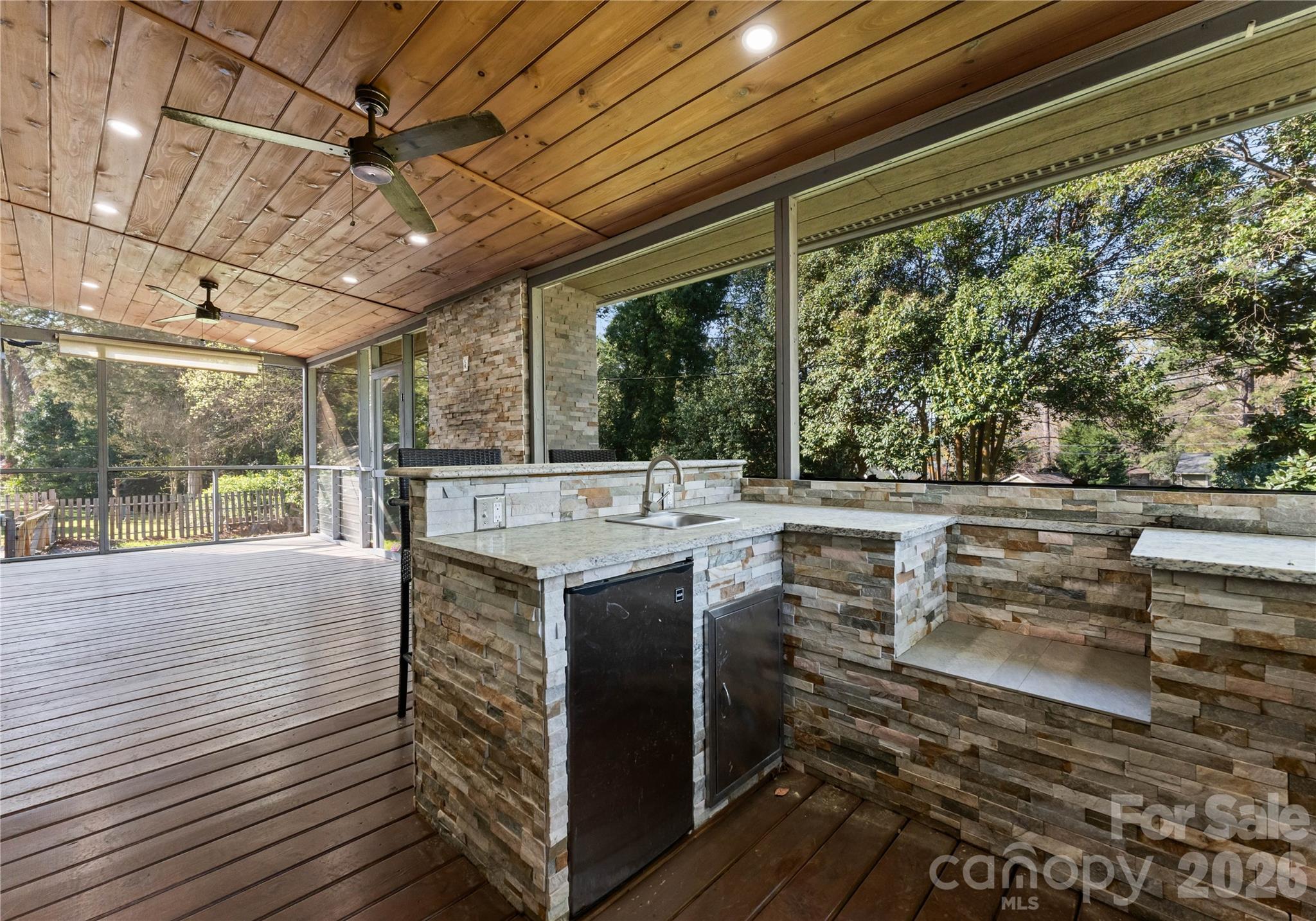 5100 White Oak Road Charlotte, NC 28210 - Photo 36 of 43 a view of a patio with table and chairs a barbeque with wooden floor and roof with a barbeque grill