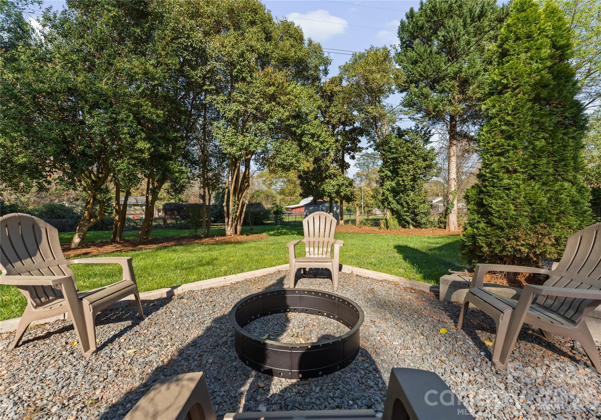 5100 White Oak Road Charlotte, NC 28210 - Photo 41 of 43 a patio with a table and chairs and a fire pit