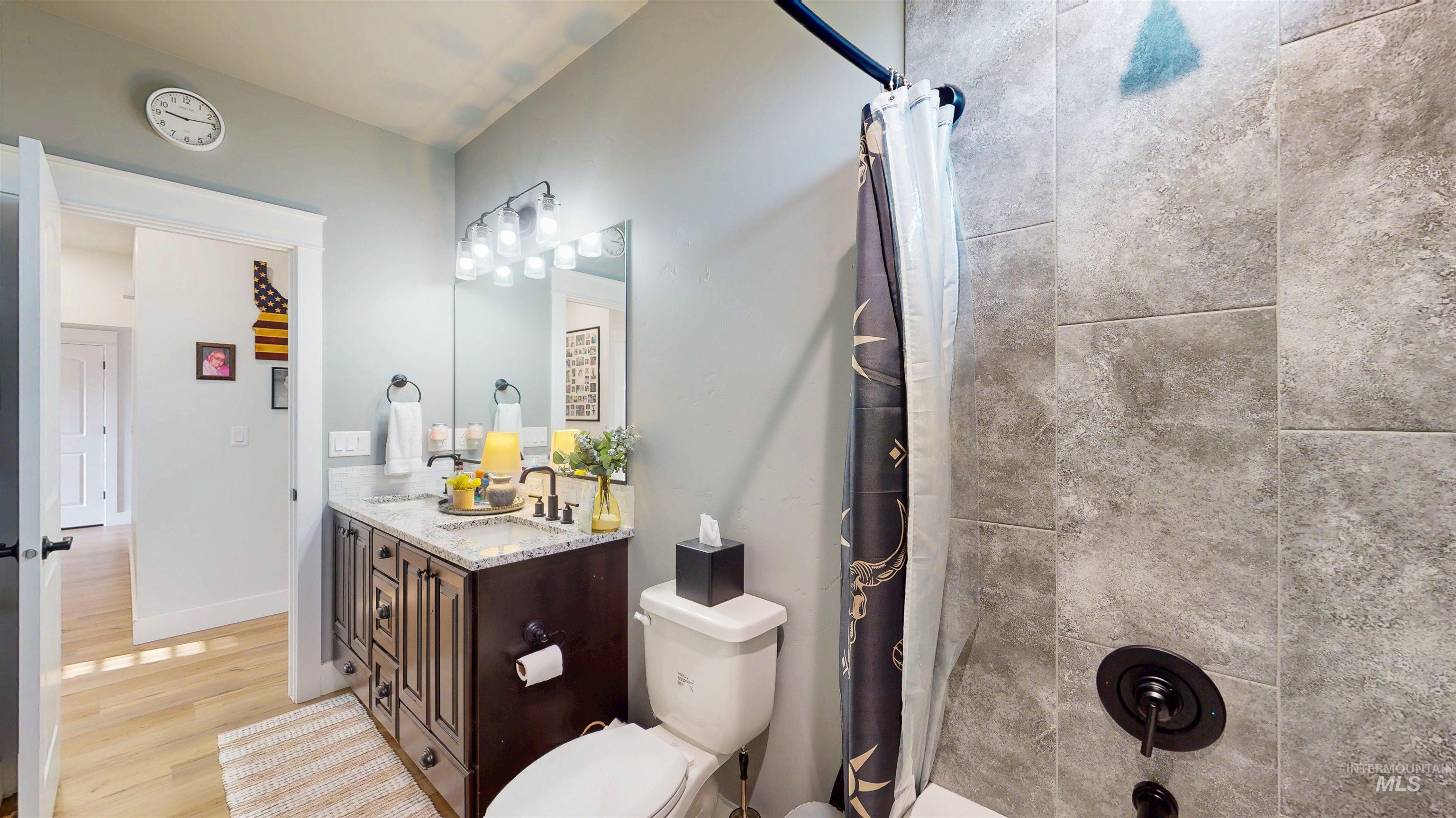 946 Kenbrook Loop Twin Falls, ID 83301 - Photo 11 of 35 Full bathroom with vanity, light wood finished floors, and shower / bath combo with shower curtain