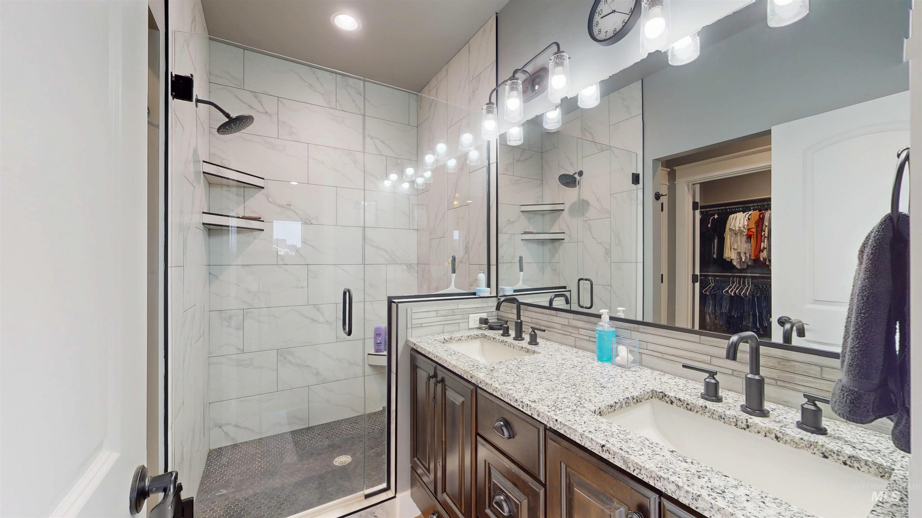 946 Kenbrook Loop Twin Falls, ID 83301 - Photo 14 of 35 Full bath with a shower stall, a spacious closet, and double vanity