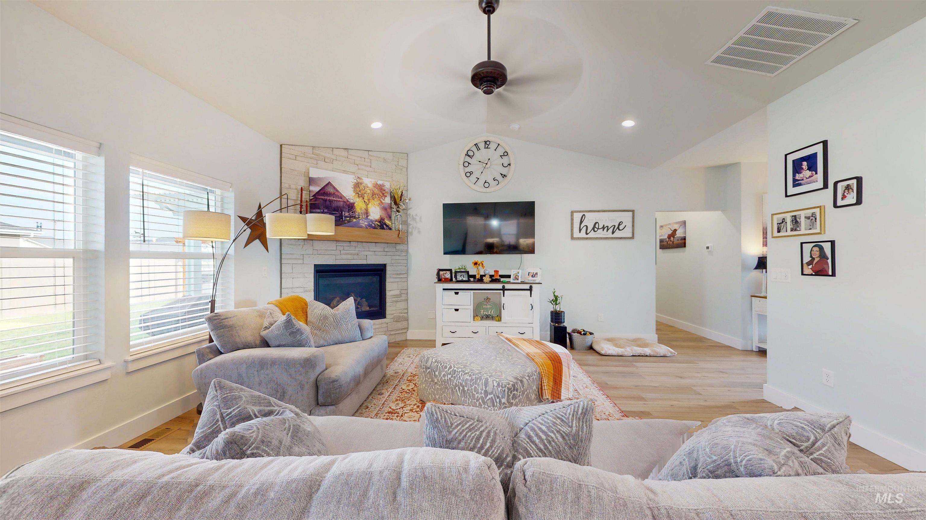 946 Kenbrook Loop Twin Falls, ID 83301 - Photo 17 of 35 Living area featuring vaulted ceiling, ceiling fan, light wood finished floors, a fireplace, and recessed lighting