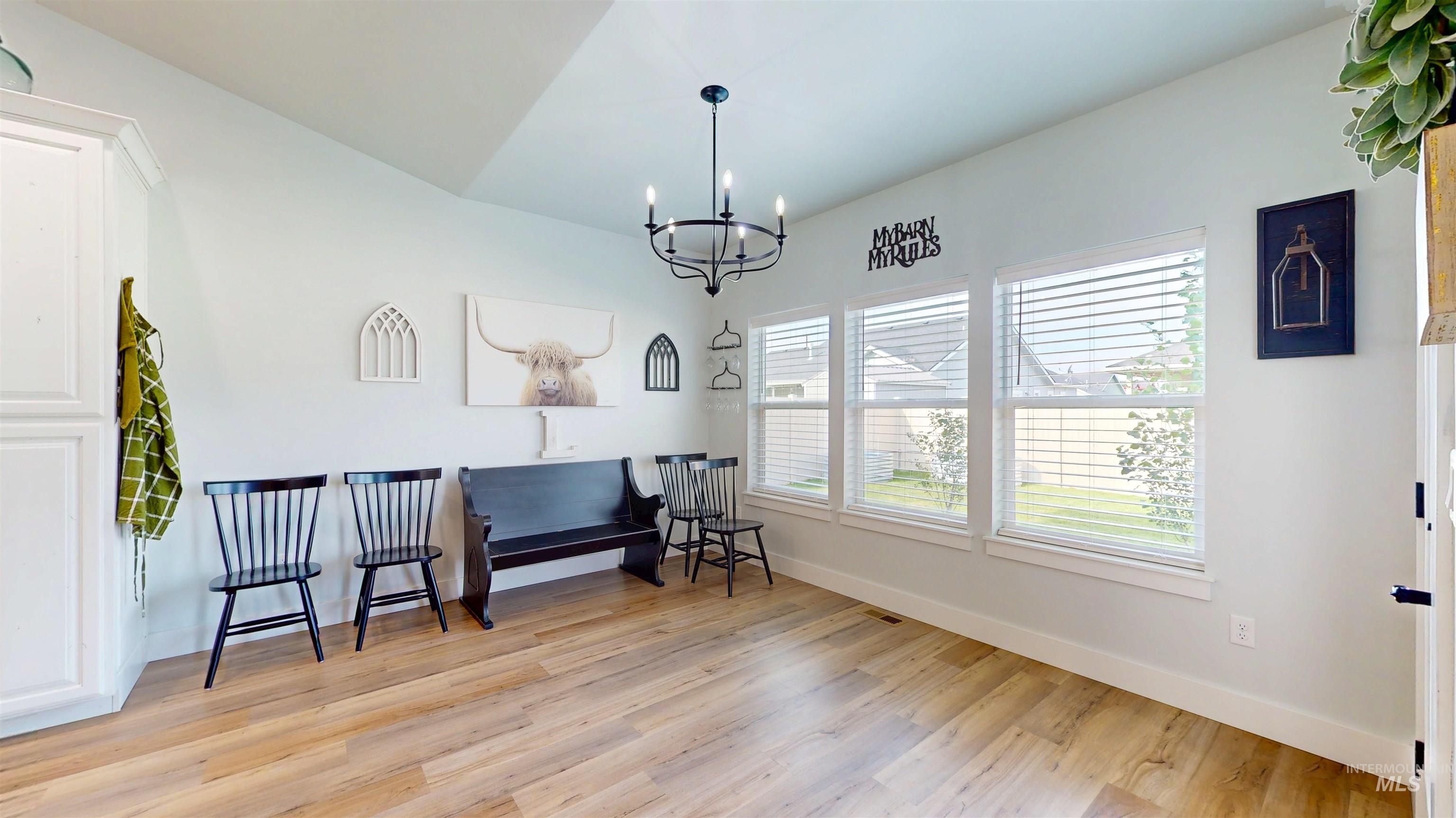 946 Kenbrook Loop Twin Falls, ID 83301 - Photo 19 of 35 Living area with light wood finished floors and a chandelier